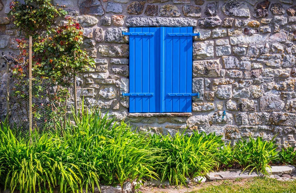 casita de piedra con ventanas azules